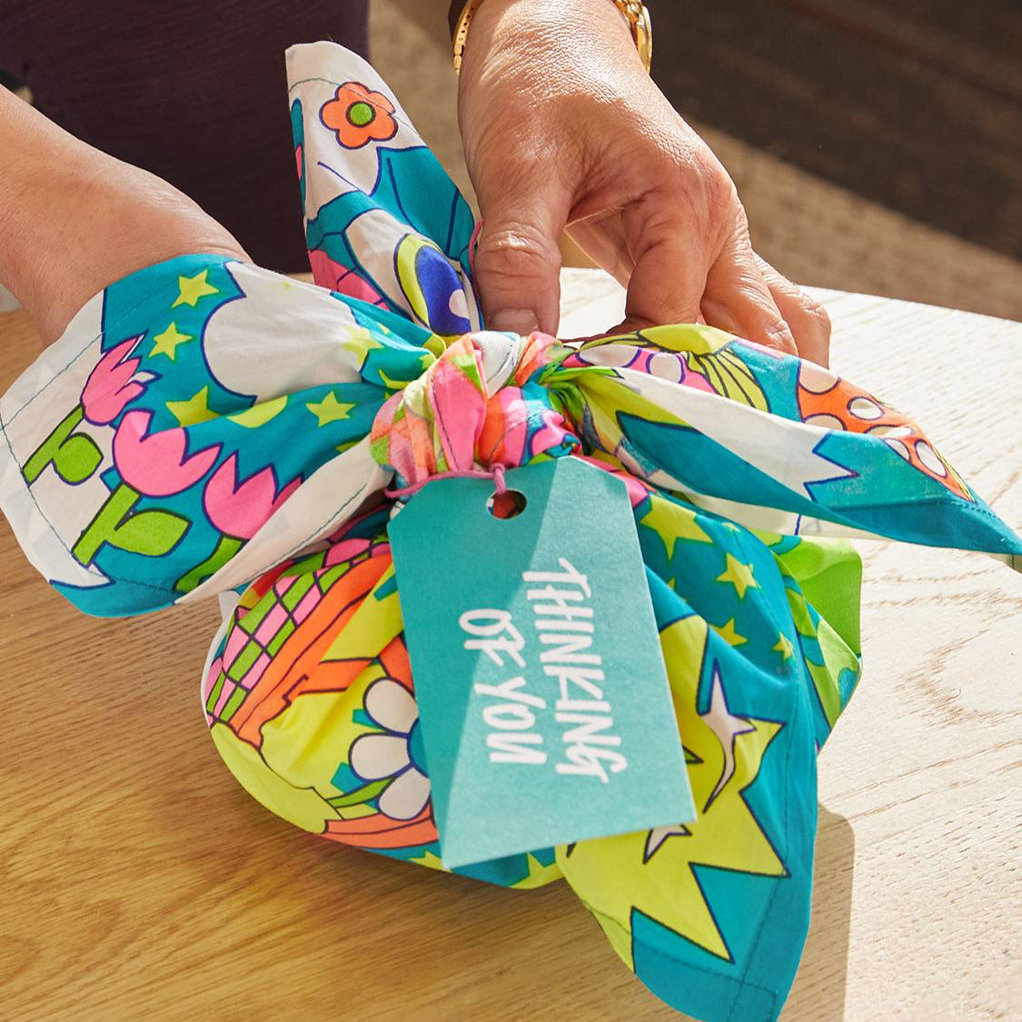 Close-up of the tied wrap with a “Thinking of You” tag, showing Lush&