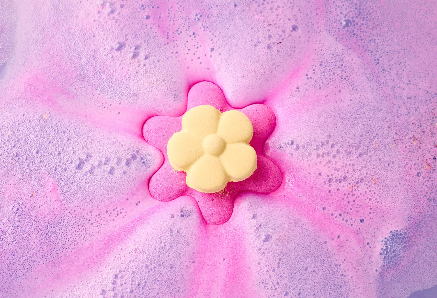 Mother’s Day flower bath bomb by Lush Lebanon dissolving in pink bath water