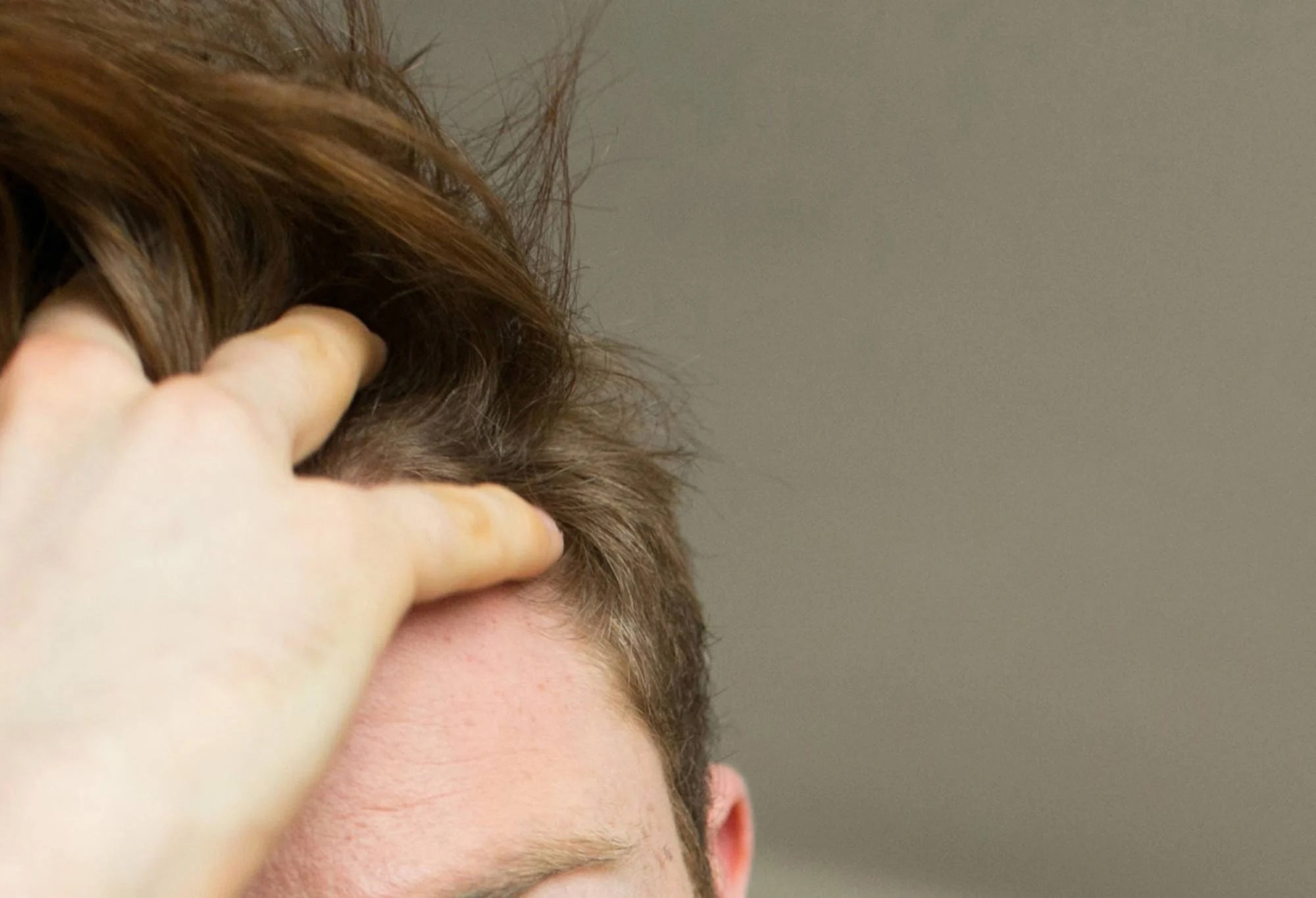 Man running his fingers through his hair