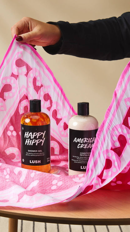 A person wrapping cream bottles with Lush&