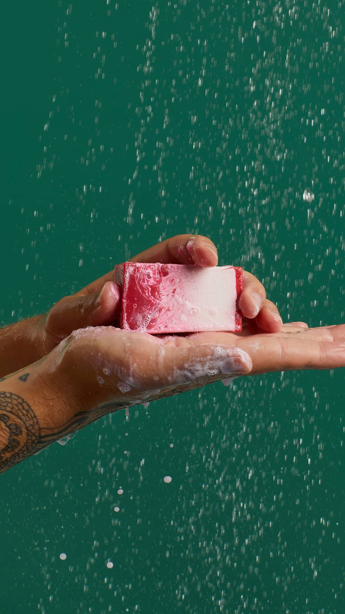 Men holding the pink soup from Lush the Comforter in his hand