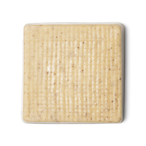Buffy. A cream coloured, rounded square shaped, solid body butter, flecked with ground rice, almonds and aduki beans.