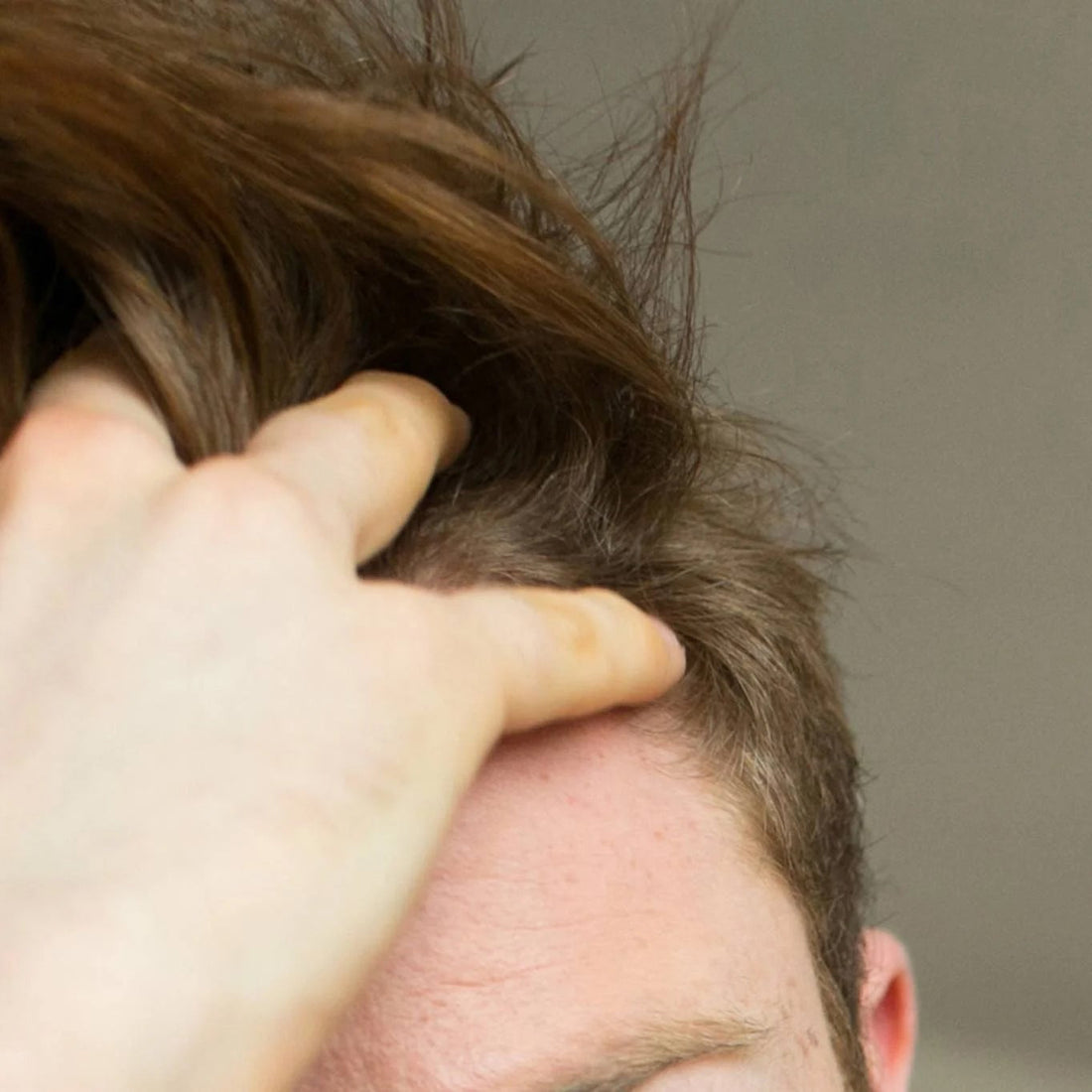Man running his fingers through his hair