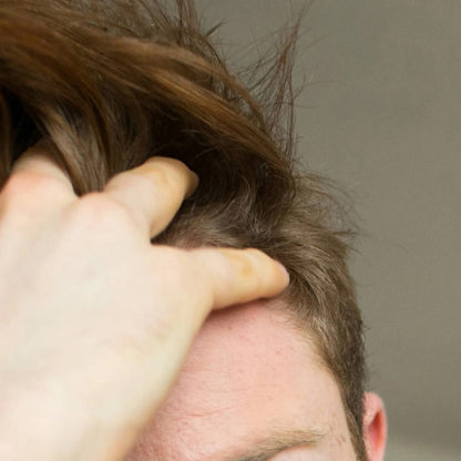 Man running his fingers through his hair