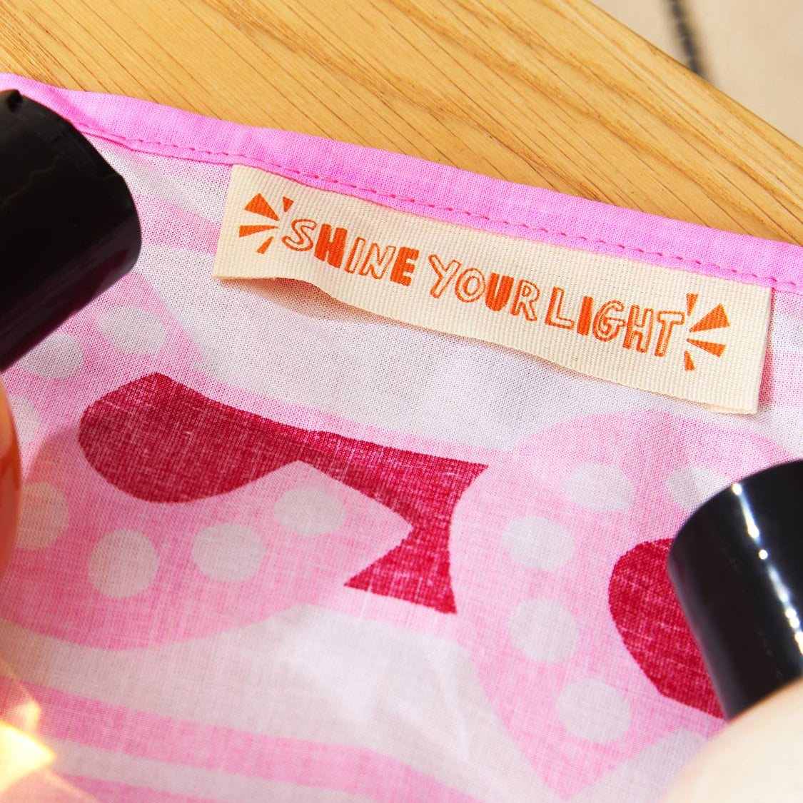 “Shine Your Light” stitched label visible inside Lush&