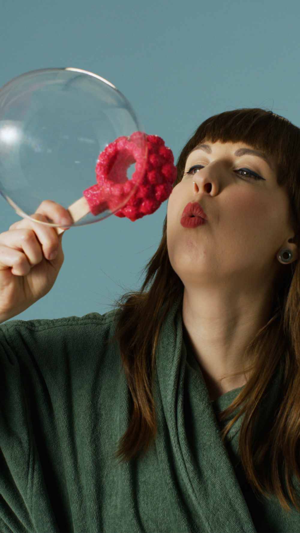 Woman blowing a bubble using Lush&
