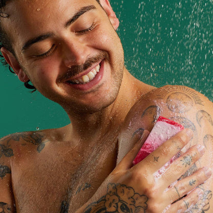 happily men scrubbing The Comforter Soap on his shoulder