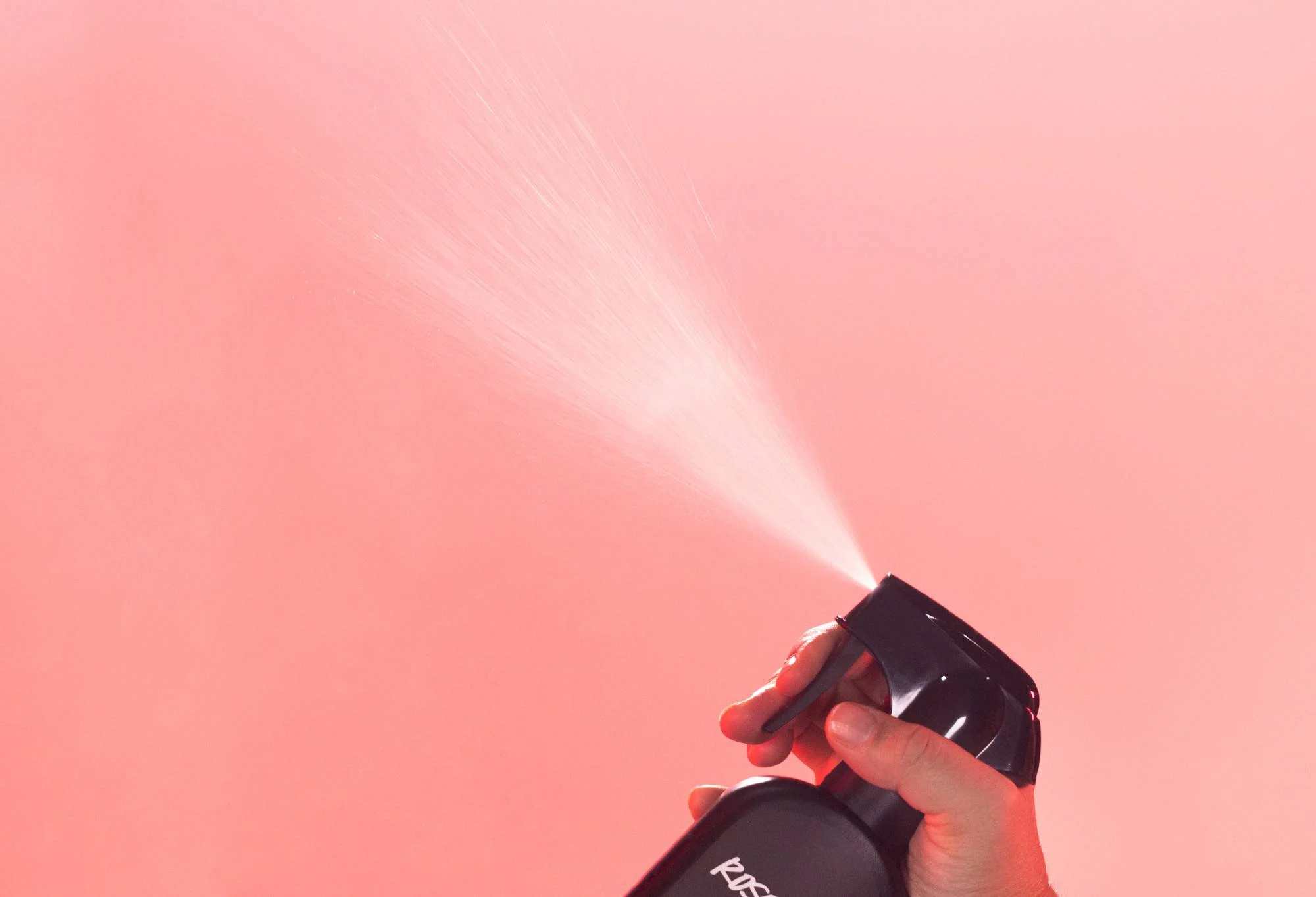 Hand spraying fine mist from Lush&