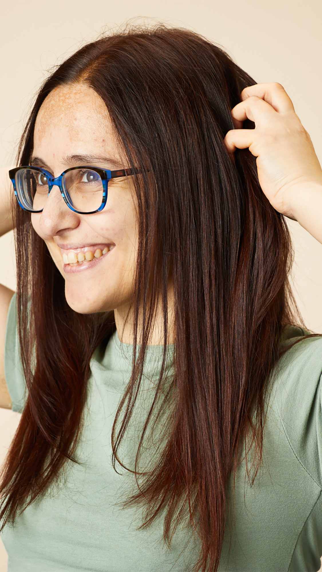 Woman smiling and showing off her hair
