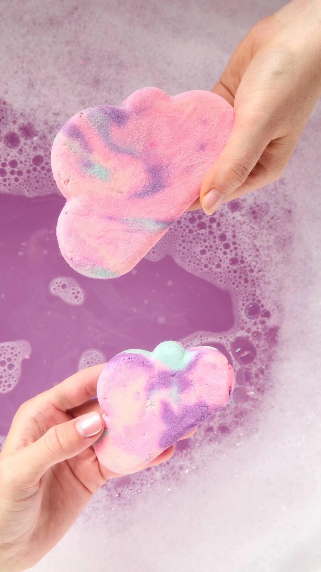 Hands holding two of Lush&