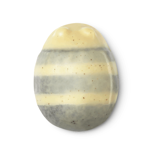 Scrubee. A cream & brown striped, bee shaped, body butter, flecked with ground coconut shell and ground almonds.